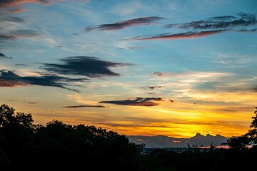 Sunrise with intense natural orange lights and idyllic dramatic scenery