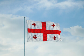 georgian flag waving in the sky with blue background