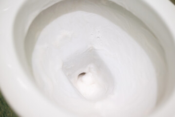 Lavatory pan in cleaning foam, toilet sanitizing. Leaving cleaning gel on dirty surface for a while for better effect