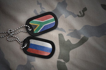 vintage army blank, dog tag with flag of south africa and russia on the khaki texture background....