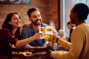 Cheerful friends toasting with drinks while gathering in pub.