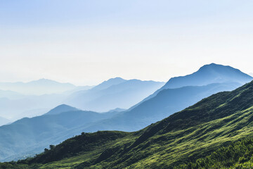 Fototapeta premium minimalist, photography, a minimalist mountain range with crisp lines and sparse vegetation, distant view.