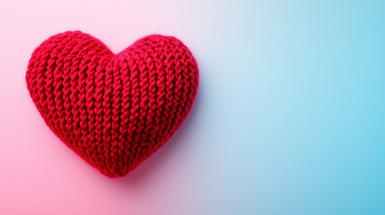 Obraz premium A close-up of a heart crafted from delicate pastel pink yarn, showcasing intricate knitted patterns and loops, set against a neutral beige backdrop for a warm, minimalist, and cozy feel