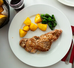Appetizing beef steak with potatoes and stewed peppers. High quality photo
