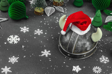 Creepy New Year concept. Handmade Viking helmet with traditional Santa Clause red hat