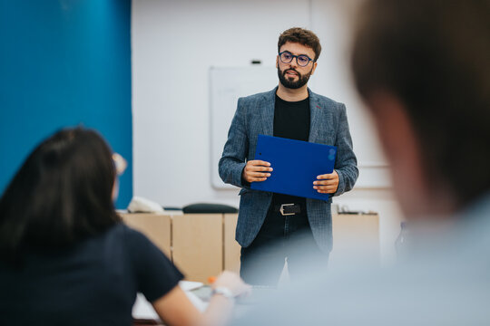 A professor aids students with their tasks during a class. The interactive session fosters learning and engagement in an educational environment.