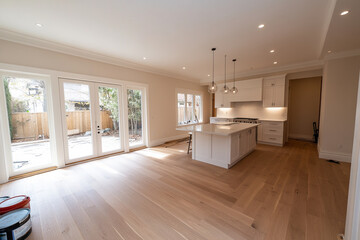 Fototapeta premium Modern kitchen space with natural light and wood flooring