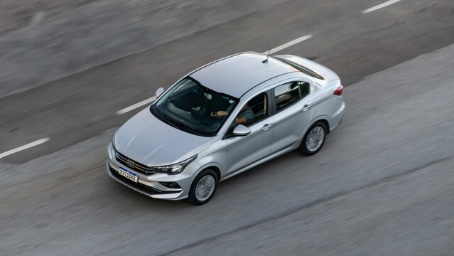 Panning shot of a Fiat Chronos on freeway, High resolution portrait of silver sedan in movement