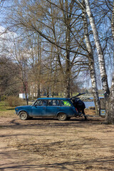 Fototapeta premium Man in the trunk of a car. Peterhof. Saint Petersburg