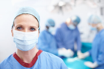 Ppe, portrait and female person as surgeon in theater for heart transplant, cardiology and operation. Doctors, medical professional and specialist in clinic, surgery and healthcare in operating room