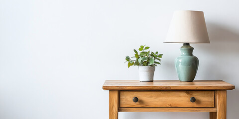 A wooden nightstand with a lamp placed on top, positioned against a clean white wall, adding a touch of simplicity and elegance to the room.