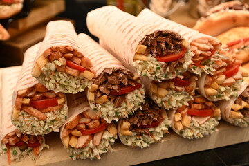 Mouth-watering meat and vegetable rolls, salmon and ham sandwiches; nuggets in the cafe window