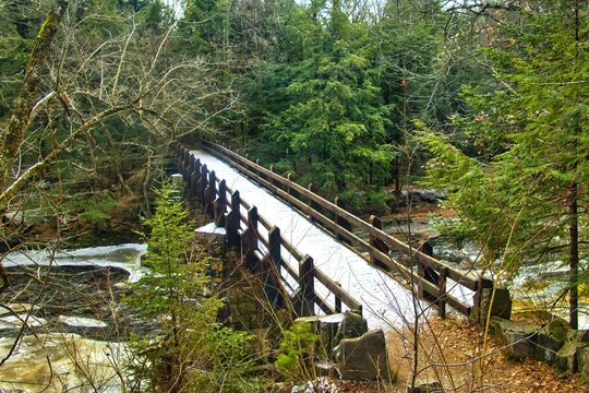 Winter&rsquo;s day closeup of a footbridge along the Ice Age Trail crossing the Eau Claire River in a densely forested rocky gorge near Aniwa, Wisconsin.