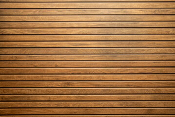 Ceramic wooden slatted panel with a natural texture and warm brown tones