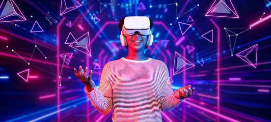 Girl looking around at geometric shape floating in metaverse. Happy teenager or gamer using VR...