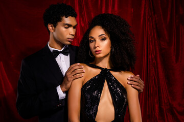 Photo of sensual loving couple together popular star hugging isolated over red fabric background