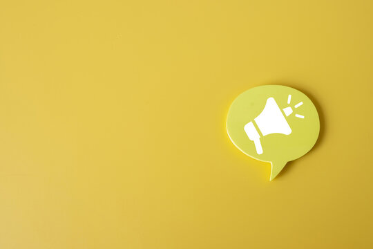 Megaphone Icon on speech bubble over yellow background with copyspace.,Communication and Announcement,Marketing Campaign,Advertising,Promotion,Social Media for business and Communication concept.