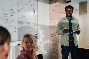 Marketing manager leading a business meeting with creative team in the office