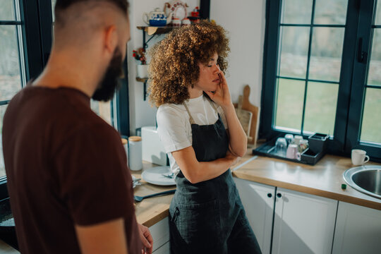 Young couple having a disagreement while cooking in kitchen