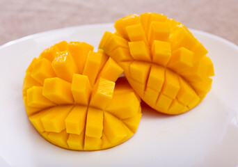 Juicy pieces of fresh diced mango served on plate