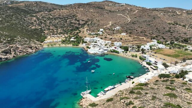 Aerial drone cinematic video of famous and picturesque seaside fishing village and beach of Faros, featuring beaches of Fasolou and Vlycho, Sifnos island, Cyclades, Greece
