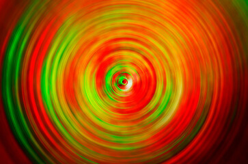 Red and green circular swirl pattern, abstract holiday background