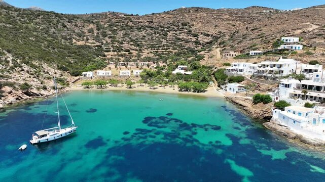 Aerial drone cinematic video of famous and picturesque seaside fishing village and beach of Faros, featuring beaches of Fasolou and Vlycho, Sifnos island, Cyclades, Greece