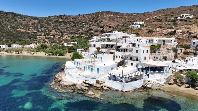 Aerial drone cinematic video of famous and picturesque seaside fishing village and beach of Faros, featuring beaches of Fasolou and Vlycho, Sifnos island, Cyclades, Greece