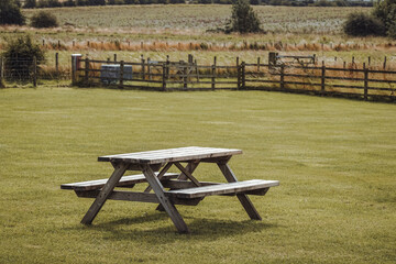 Peaceful british landscape with a bench, picnic area