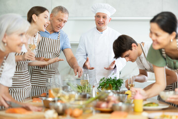 Chef teaches how to beat raw eggs with a whisk in a cooking class