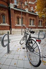 Fototapeta premium Bicycle parked by the red brick church