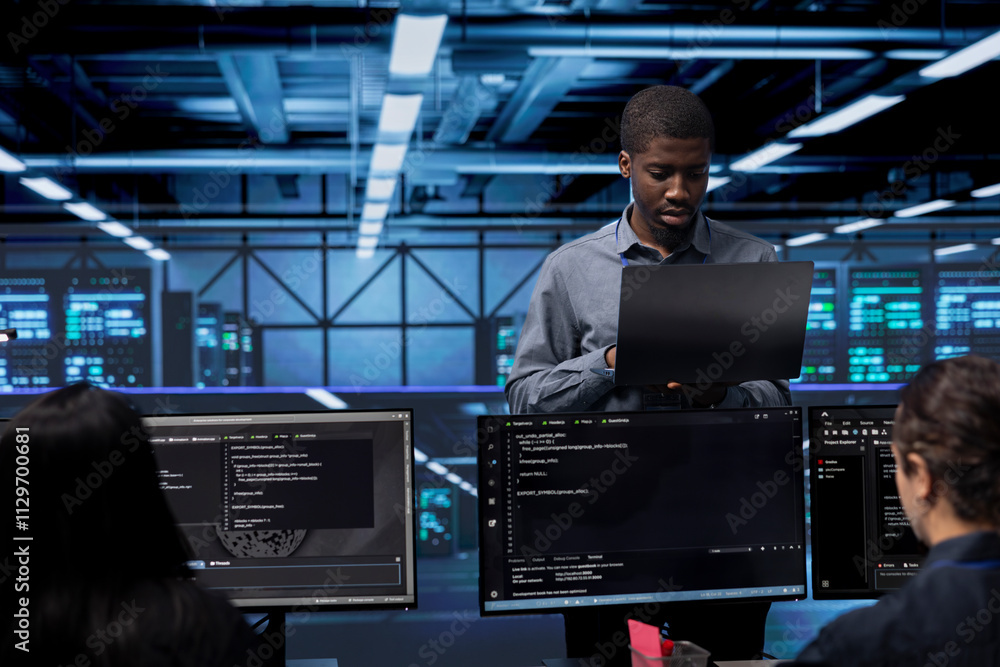Poster admin doing routine maintenance in data center to extend equipment life span and avoid downtime. wor