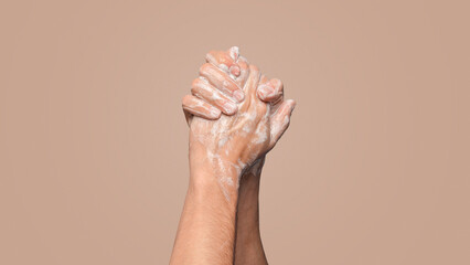 Hygiene against virus. Man washing hands with soap against blue background, closeup view. Panorama...