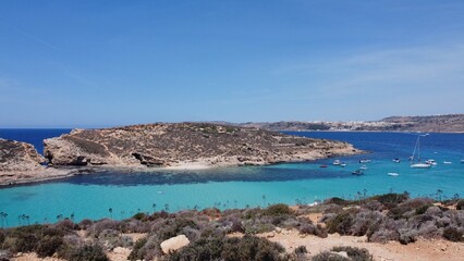 Comino, Malta 29.05.2024 -Beautiful white sand beach on Uninhabited Cominotto island, and Blue lagoon Comino, Malta. Aerial establishing shot. High quality photo