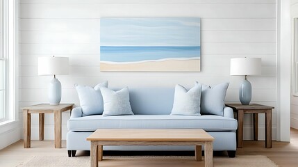 A cozy living room featuring a light blue sofa, decorative pillows, wooden tables, and a beach-themed painting, creating a serene coastal ambiance.