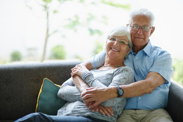 Embrace, portrait and senior couple on sofa with love, care or happy marriage in retirement together. Hug, elderly man and old woman on couch with smile, support or comfort in morning bonding in home