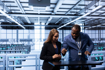 Engineers looking at AR visualization, doing disaster recovery planning in data center. Coworkers...