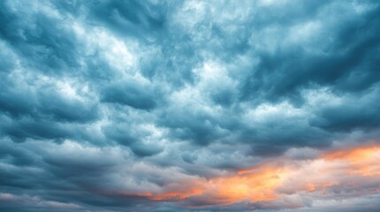 Obraz premium Dramatic Sky with Deep Clouds and Colorful Sunset Glow Above Horizon