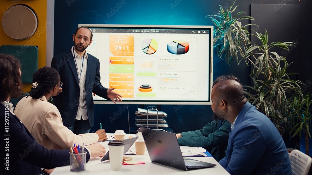 Poster management consultant gathering his employees for a status update meeting in boardroom, interactive 