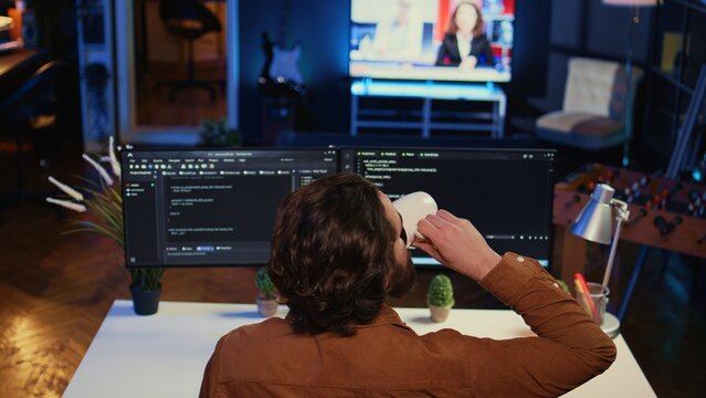 Admin using javascript coding language to fortify security and safeguard consumer data, remotely working for IT company. Software developer upgrading binary code scripts on computer terminal, camera B