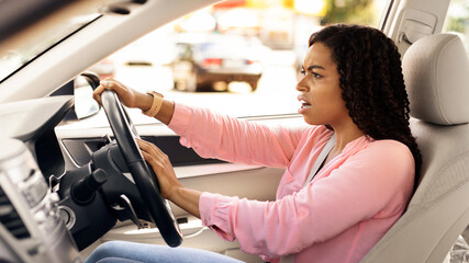 Angry black female driving car shouting at somebody, emotionally reacting to accident or road jam...