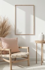 A wooden armchair with a pink pillow sits in front of a blank picture frame in a white room with natural light
