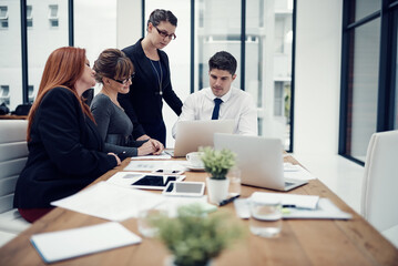 Laptop, employees and finance development in office, meeting and team with investment report. Business people, brainstorming and online for income research, workplace and support revenue proposal