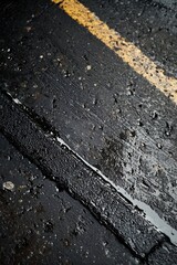 Fototapeta premium Wet road with yellow stripes after rain