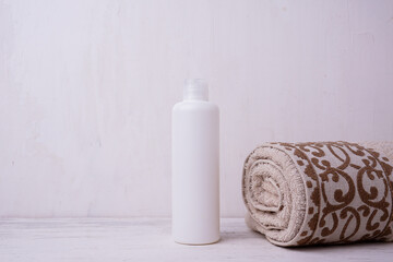 Cosmetic bottle mockup, on a beige background, hand holding the bottle, mockup for branding your product
