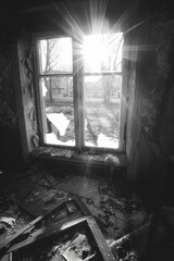Fototapeta premium Sunlit Window In A Derelict Building Showing Shattered Glass