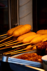 golden crispy Taiwanese corn dogs are neatly arranged on the rack