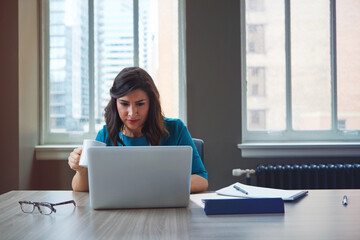 Coffee, business woman and laptop in office for asset management, review client profit data and...