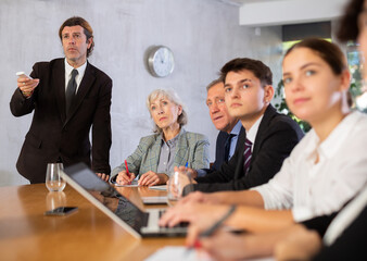 Successful businessman tells his colleagues the presentation and future plans of the company