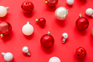 Composition with Christmas balls on red background